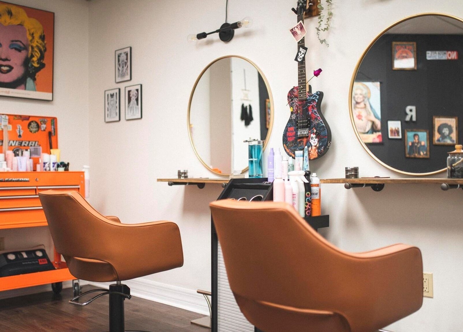 Chic interior of Roxstar Hair Design in Punta Gorda, Florida, US, featuring art, mirrors, and styling chairs.