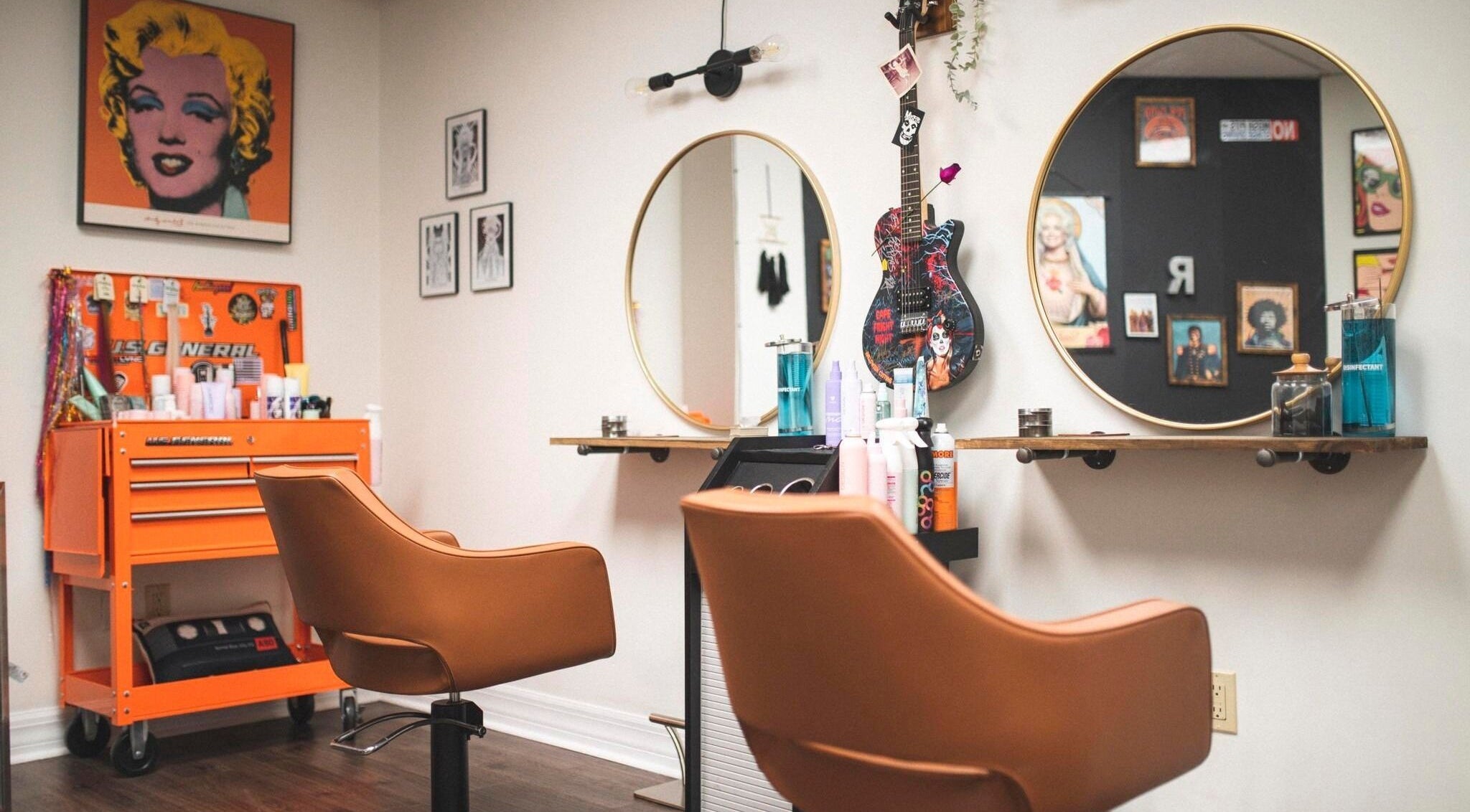 Chic interior of Roxstar Hair Design in Punta Gorda, Florida, US, featuring art, mirrors, and styling chairs.