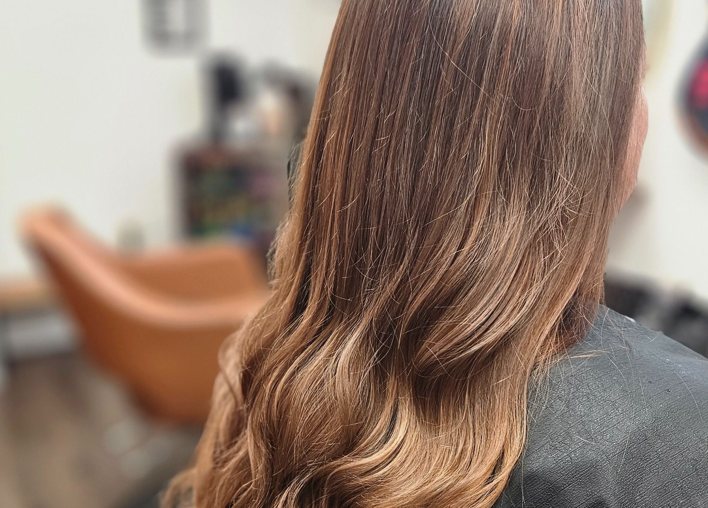 Long, styled hair at Roxstar Hair Design in Punta Gorda, Florida, US, showcasing a sleek salon interior.