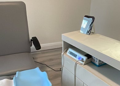 Clean treatment area at MY FOOT CLINIC Winton, Bournemouth, GB featuring a chair and equipment.