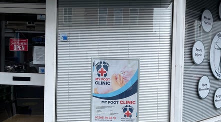 Entrance of MY FOOT CLINIC (Parkstone) in Poole, England, GB with open sign and clinic poster displayed.