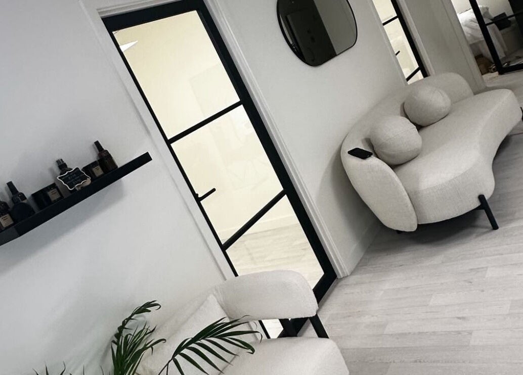 Chic seating area at Thesachhouse, Wigan, England, GB, with beige sofa and sleek decor.