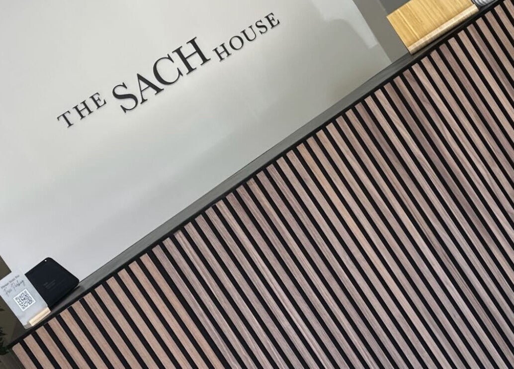 Modern reception desk at Thesachhouse, Wigan, England, GB, featuring stylish wood paneling.