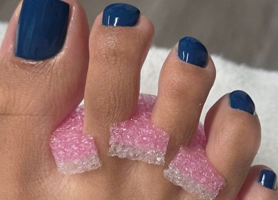 Navy blue pedicure at Celeste's Nail Studio in Fairfax, Virginia, US showcases elegant, well-groomed toes.