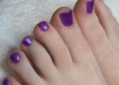 Purple glitter pedicure at Celeste's Nail Studio, Fairfax, Virginia, US, showcasing elegant nail art.