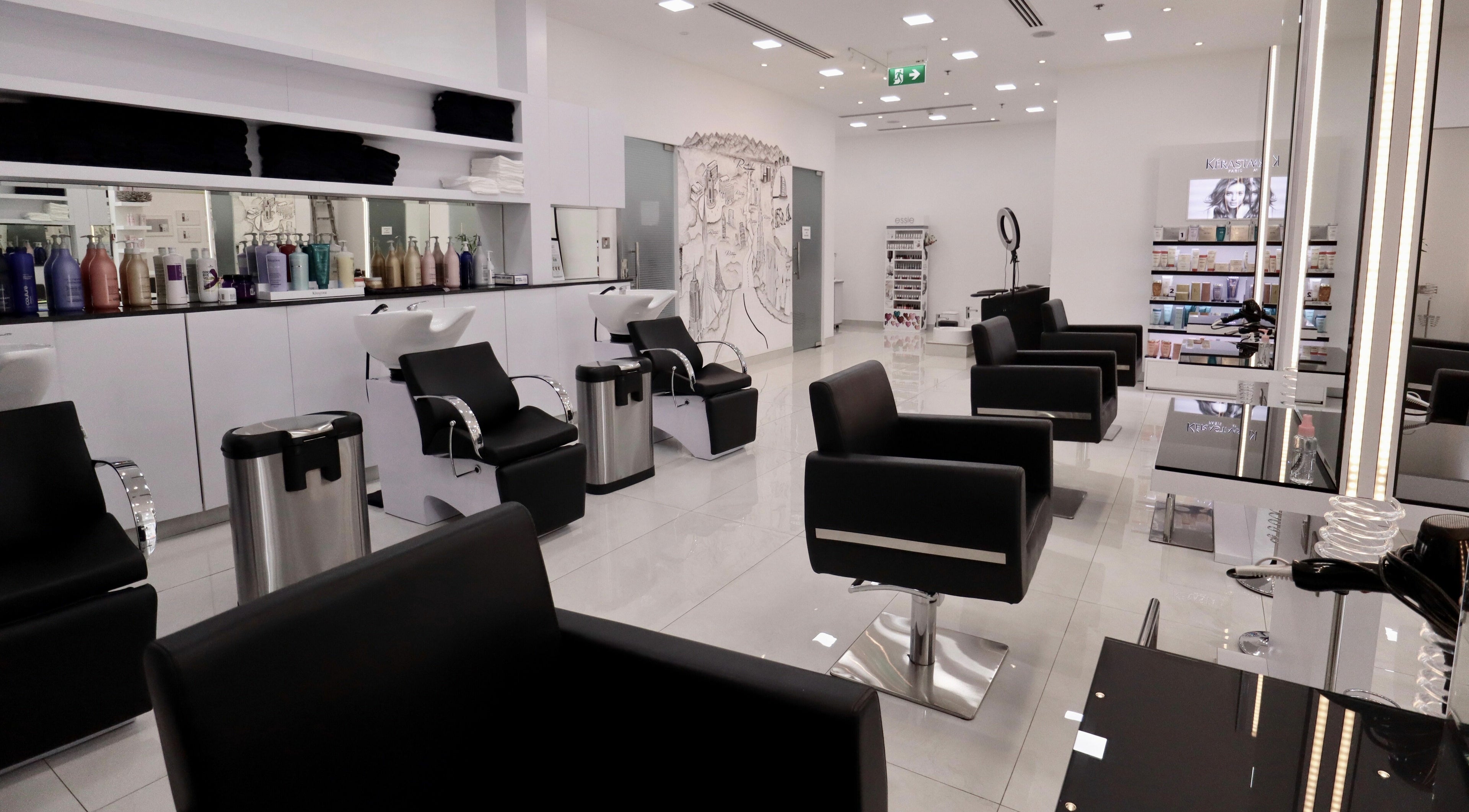 Elegant interior of Rami H Beauty Salon in Dubai, AE, featuring modern styling chairs and sleek decor.