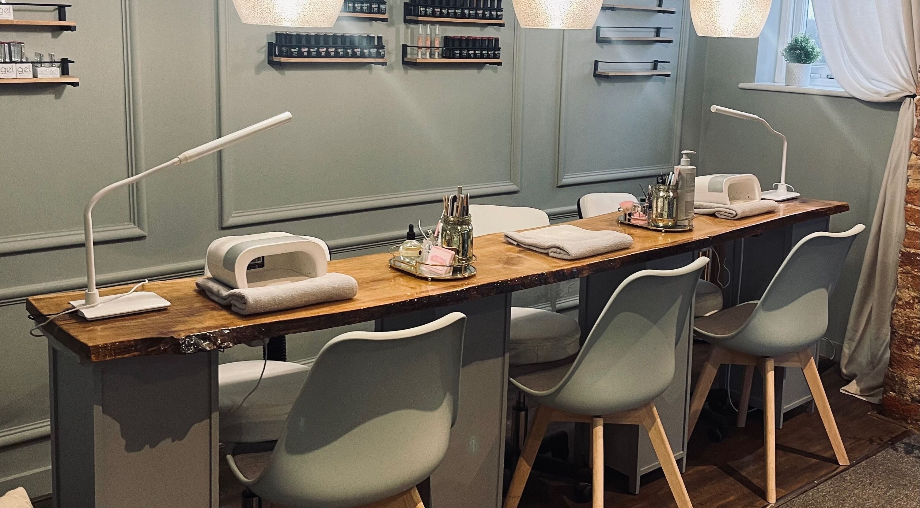 Modern nail station at Unity Hair and Beauty in Hook, England, GB, featuring elegant decor and tools.