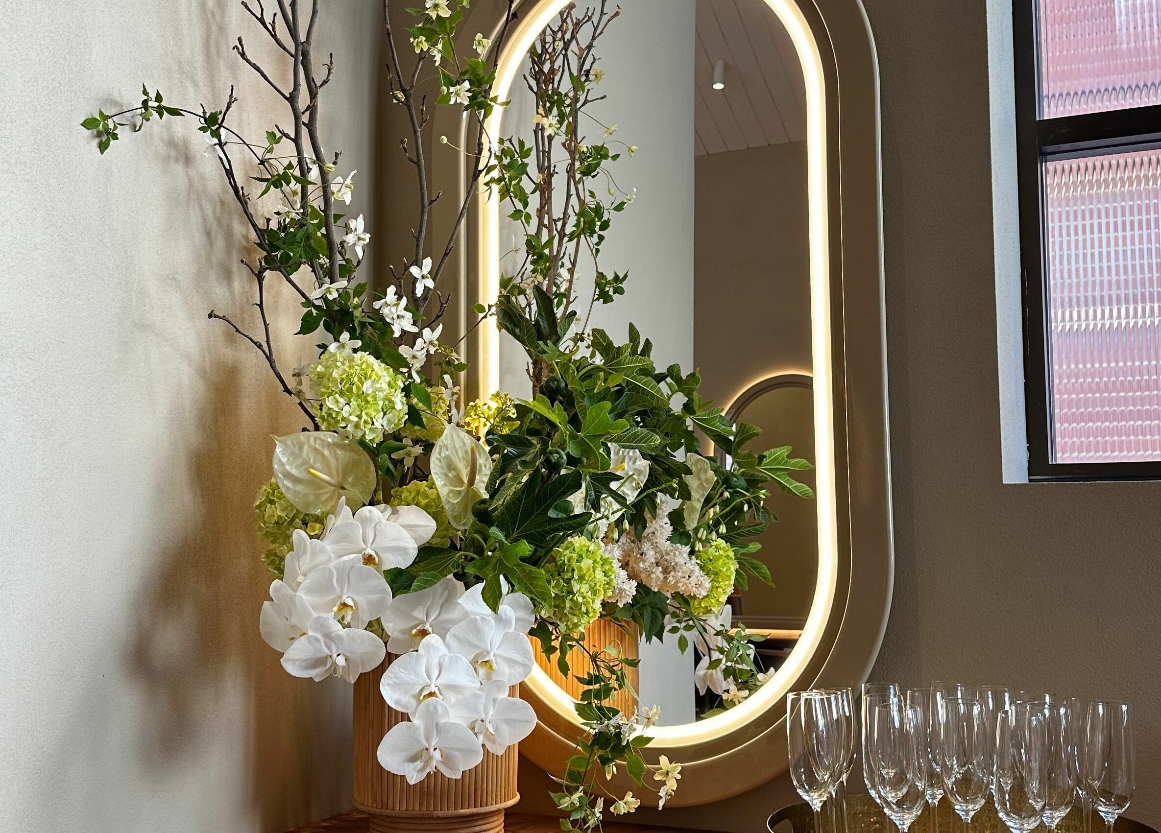 Elegant floral arrangement next to illuminated mirror at Bennett and Barkell, Wagga Wagga, New South Wales, AU.