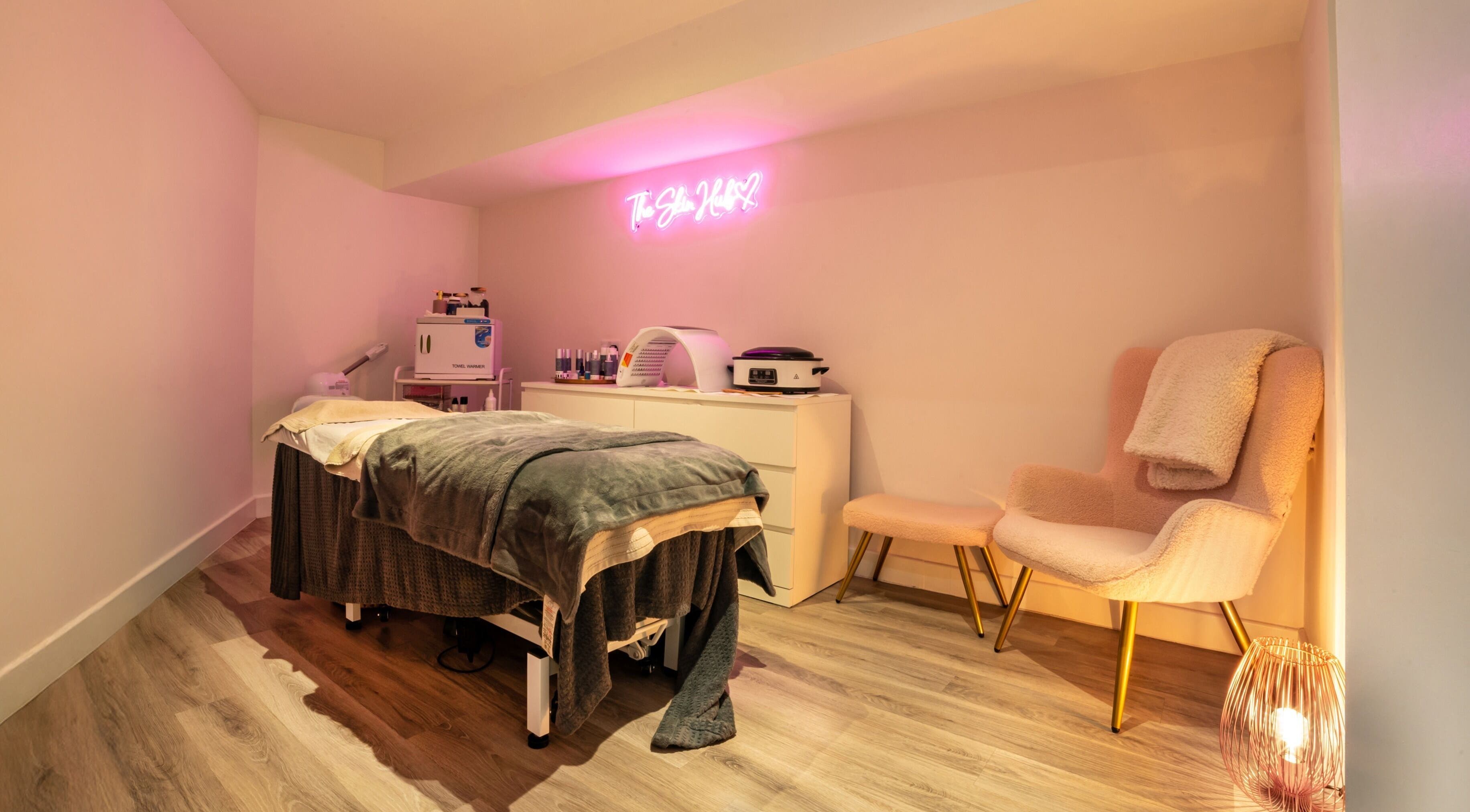 Cozy treatment room at The Beauty Barn Leicester, Leicester, England, GB, featuring a treatment bed and ambient lighting.