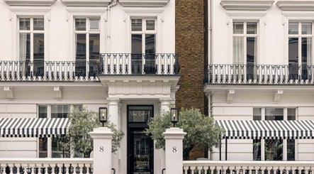 Wellness at The Laslett, a chic exterior in London, England, GB, showcasing classic architecture and striped awnings.