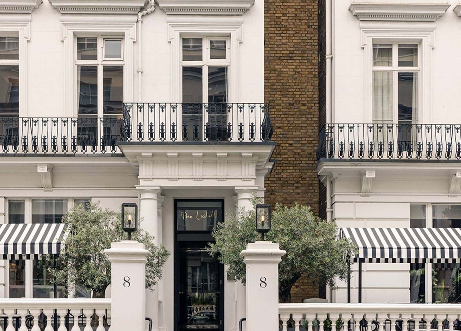 Elegant exterior of Wellness at The Laslett in London, England, GB with striped awnings and classic architecture.