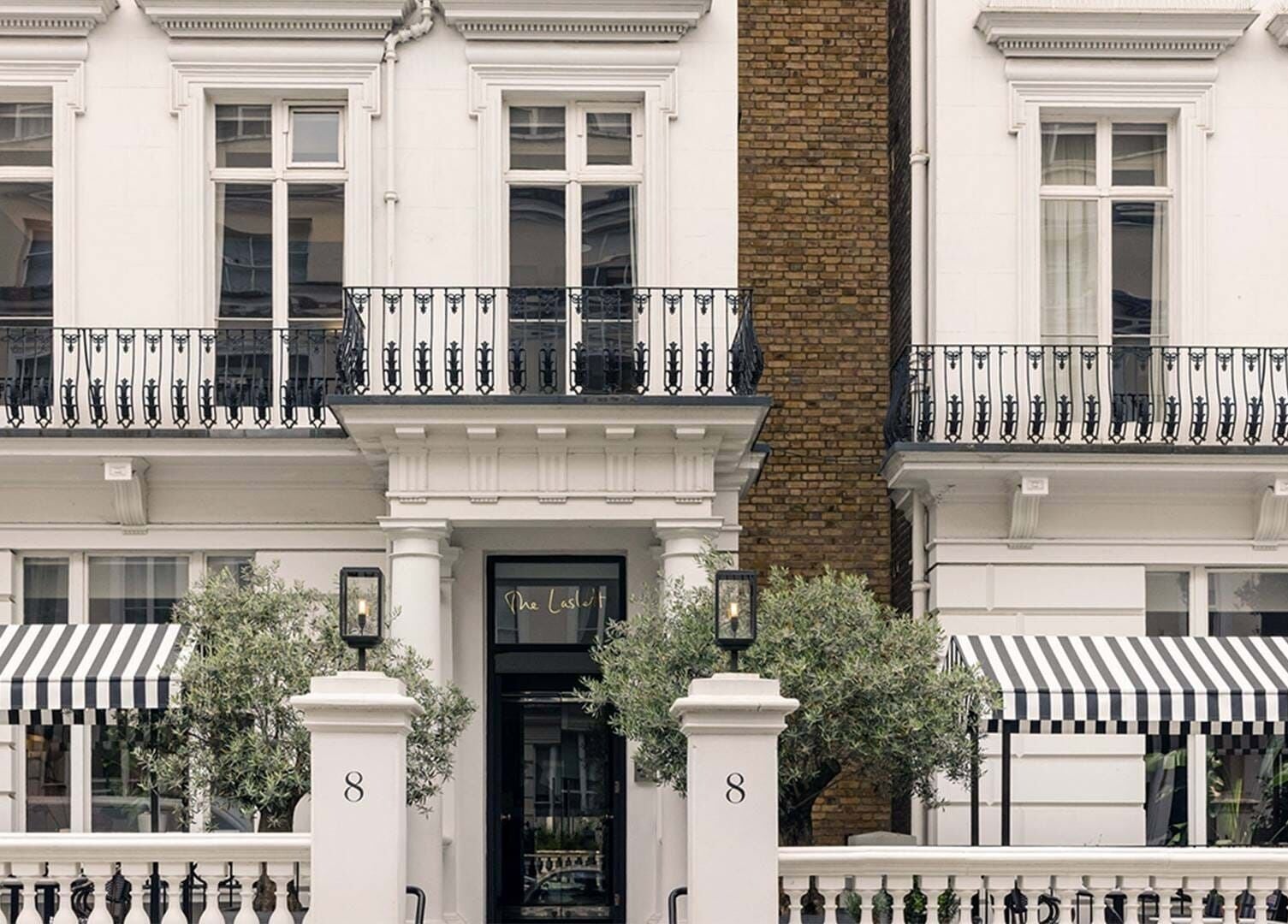 Elegant exterior of Wellness at The Laslett in London, England, GB with striped awnings and classic architecture.