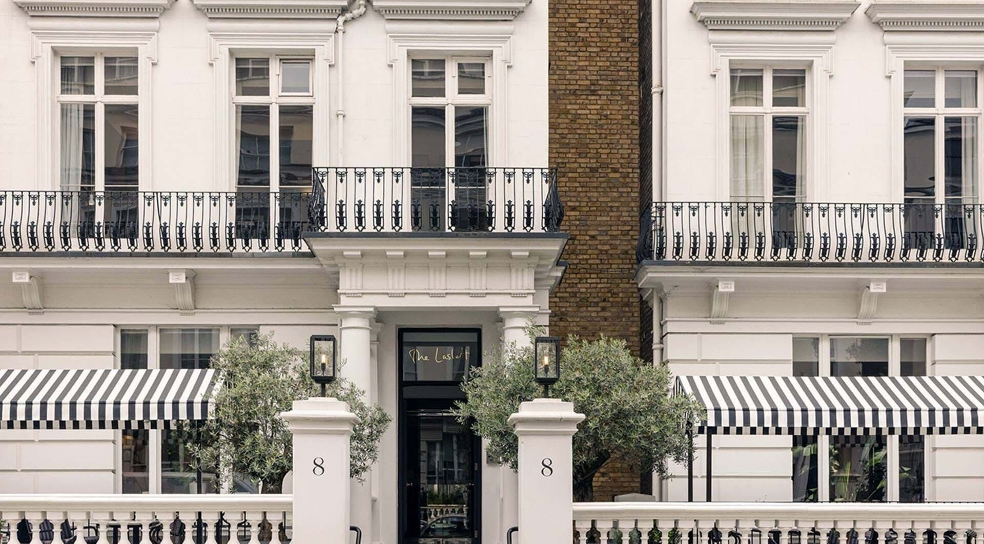 Elegant exterior of Wellness at The Laslett in London, England, GB with striped awnings and classic architecture.