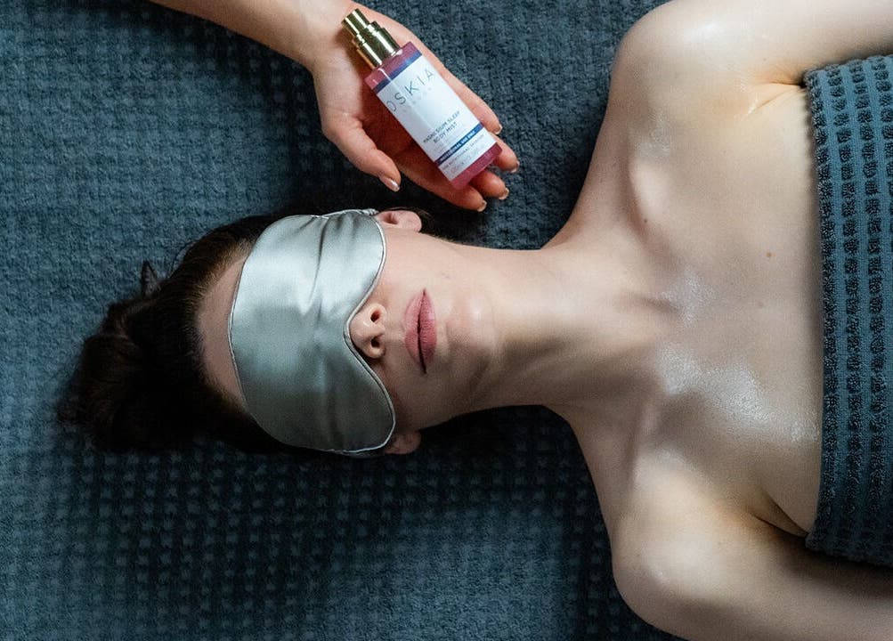Woman relaxing with eye mask and skincare at Wellness at The Laslett, London, England, GB for ultimate comfort.