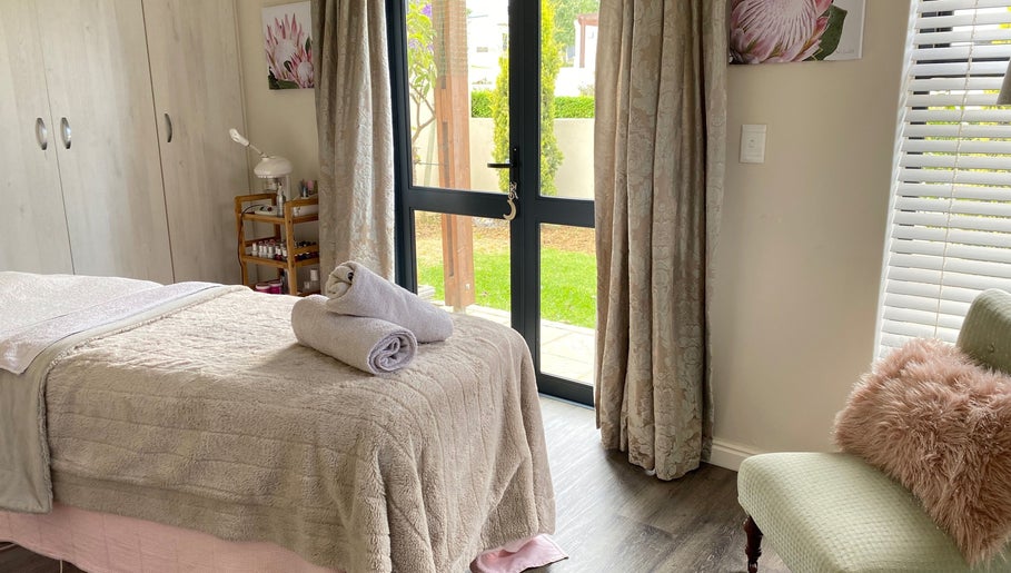 Tranquil spa room at All about Skin Studio, Cape Town, Western Cape, ZA, featuring plush bedding and natural light.