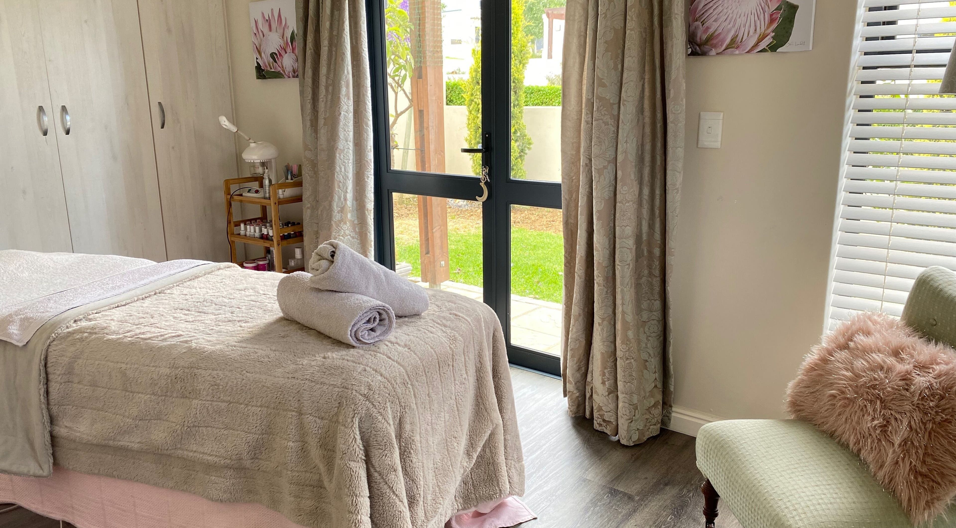 Tranquil spa room at All about Skin Studio, Cape Town, Western Cape, ZA, featuring plush bedding and natural light.