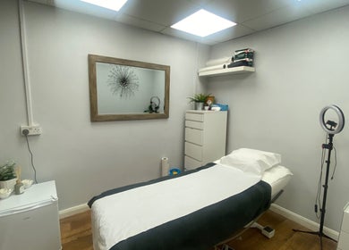 Serene treatment room at Head to Toe, Grassmoor, England, GB, featuring a comfy bed and calming decor.