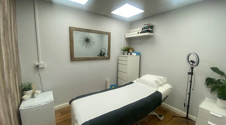 Serene treatment room at Head to Toe, Grassmoor, England, GB, featuring a comfy bed and calming decor.
