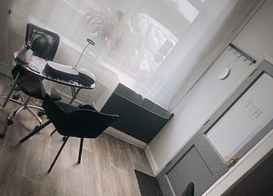 A serene beauty treatment area at Head to Toe, Grassmoor, England, GB with natural lighting and chic decor.