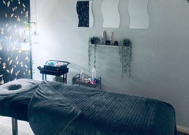 Peaceful massage room at Head to Toe in Grassmoor, England, GB with elegant decor and dim lighting.