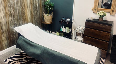 Tranquil spa room at Head to Toe in Grassmoor, England, GB, featuring a massage bed and rustic decor.