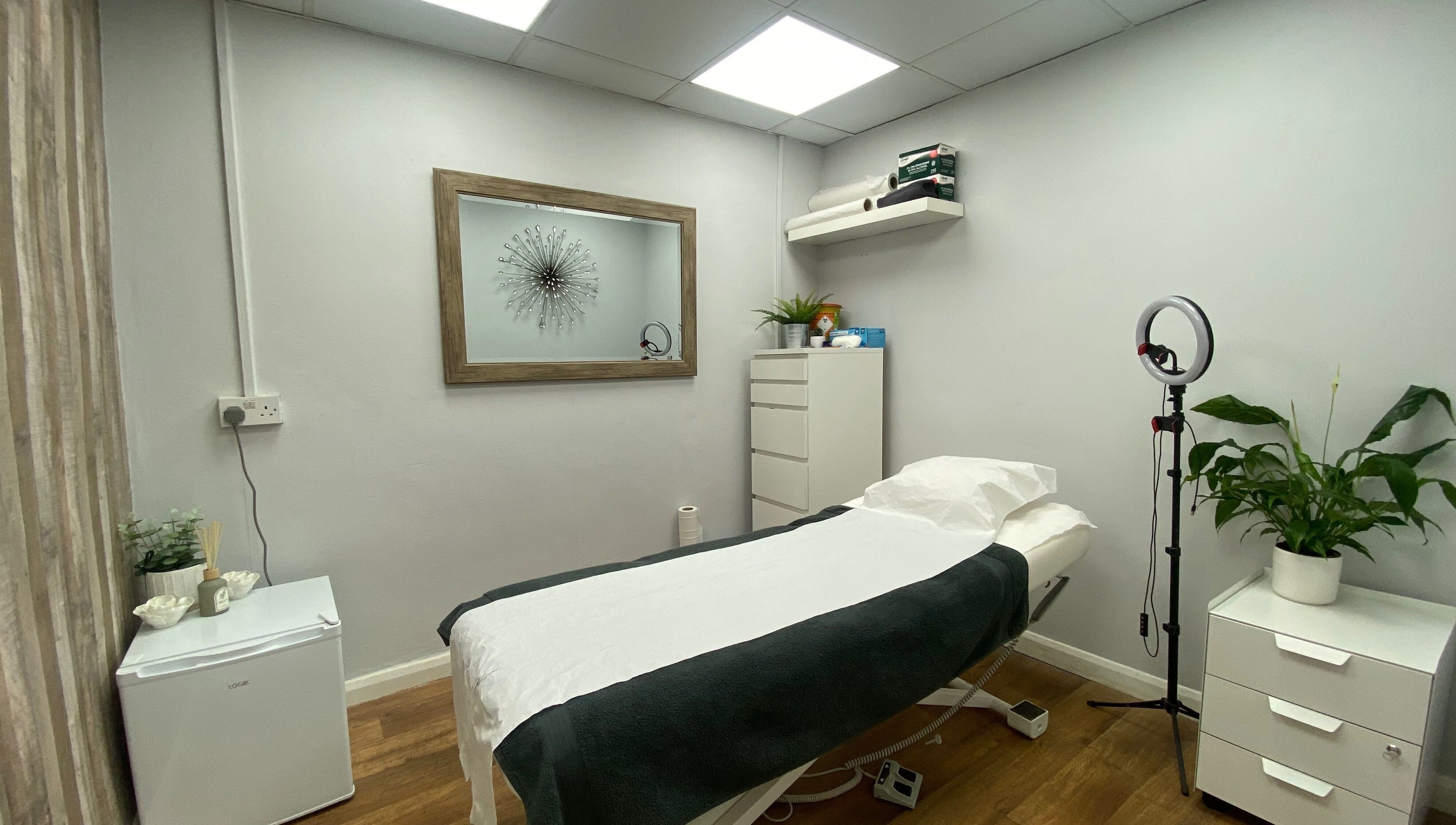 Calm treatment room at Head to Toe in Grassmoor, England, GB with bed, decor, and lighting.