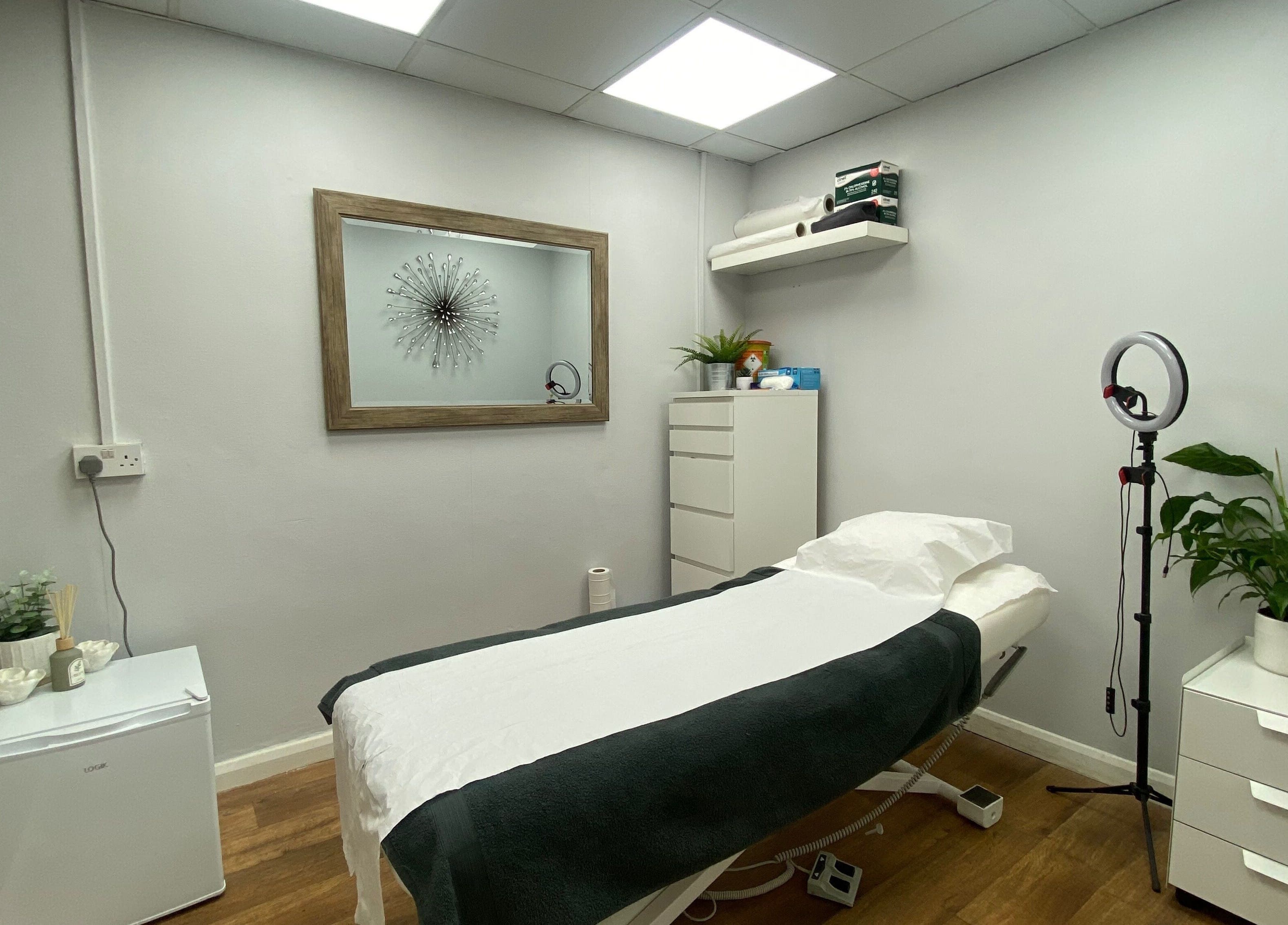 Calm treatment room at Head to Toe in Grassmoor, England, GB with bed, decor, and lighting.
