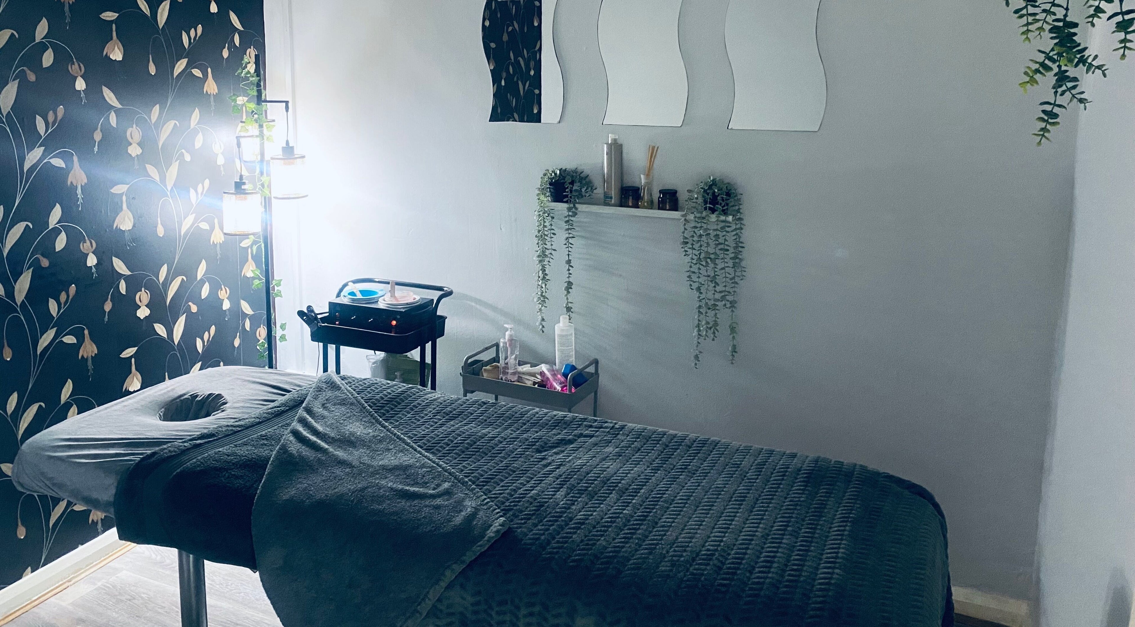 Relaxing massage room at Head to Toe in Grassmoor, England, GB with ambient lighting and comforting decor.