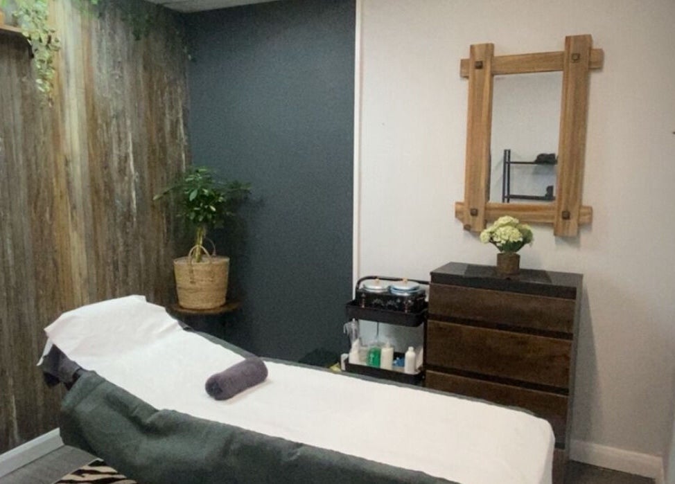 Cozy massage room at Head to Toe, Grassmoor, England, GB with wood accents and a calming atmosphere.