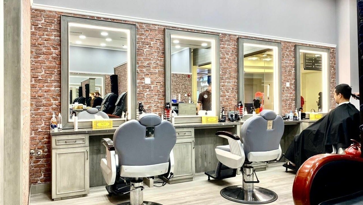 Stylish barber chairs at Vintage Men's SPA, Al Wahada Mall, Abu Dhabi, AE with brick wall decor.