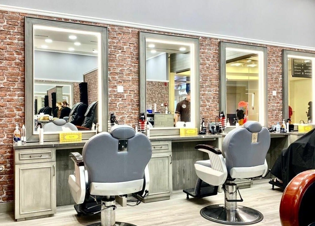 Stylish barber chairs at Vintage Men's SPA, Al Wahada Mall, Abu Dhabi, AE with brick wall decor.