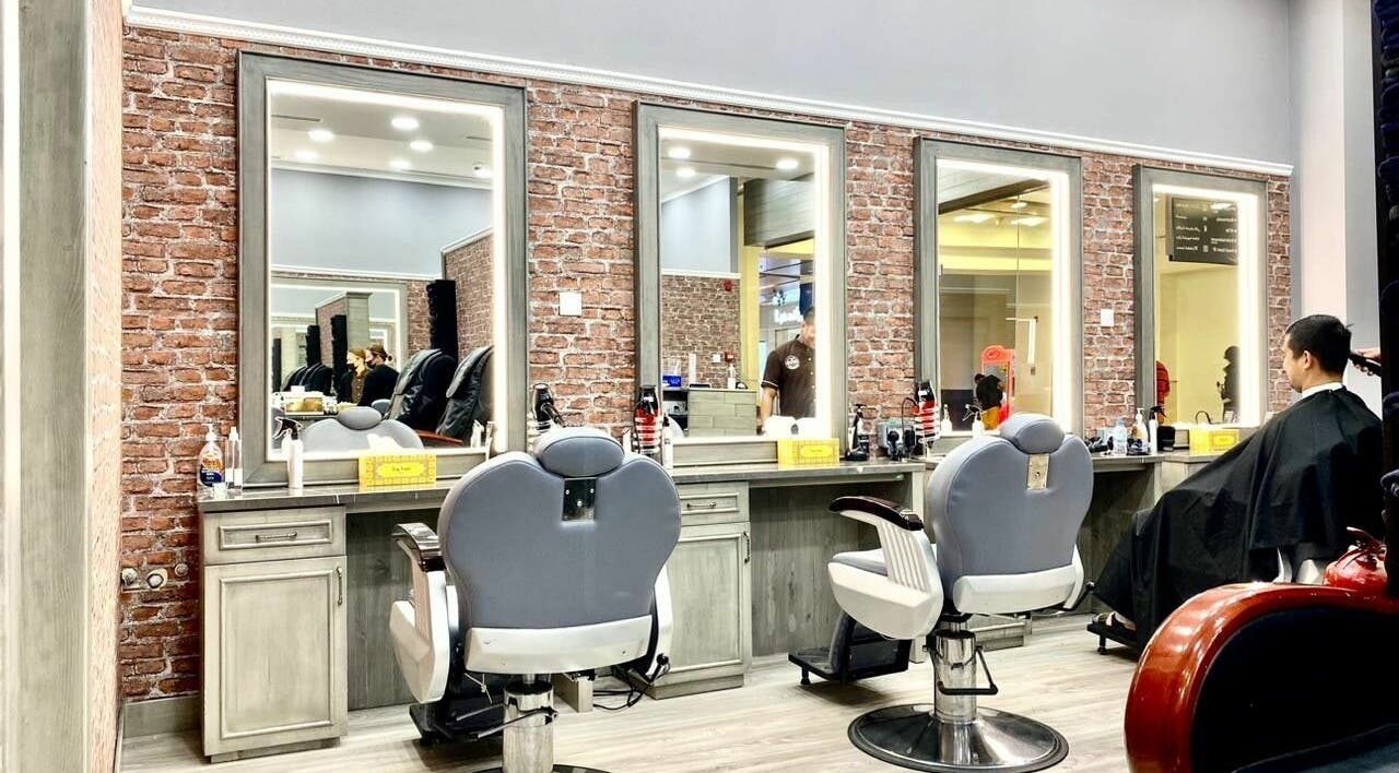 Stylish barber chairs at Vintage Men's SPA, Al Wahada Mall, Abu Dhabi, AE with brick wall decor.