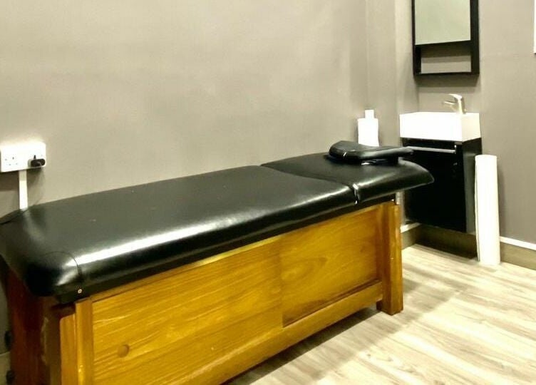 Relaxing massage room at Vintage Men's SPA - Al Wahada Mall, Abu Dhabi, AE with a sleek black therapy table.