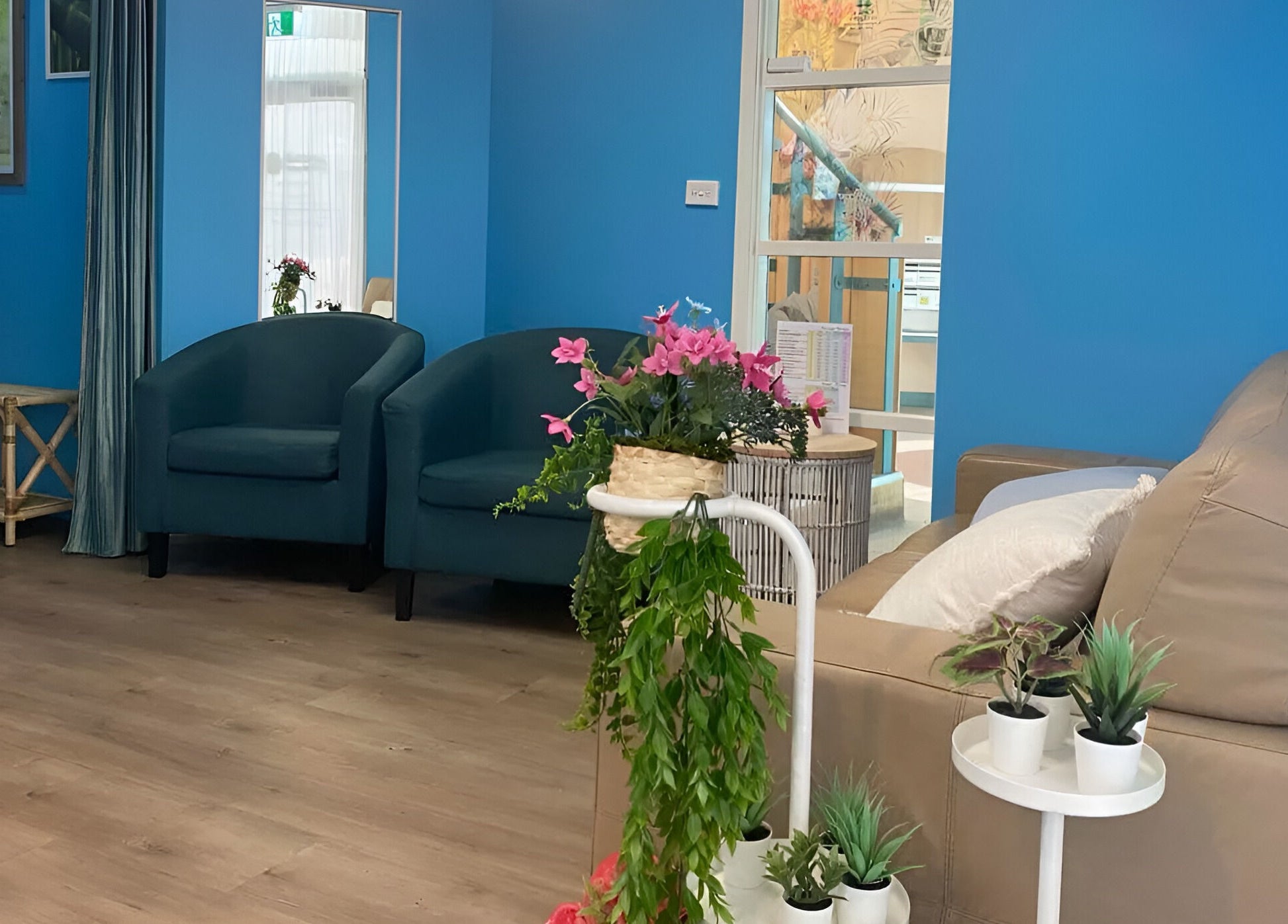 Relaxing lounge area at Thai Unique Massage at Dickson, featuring plush seating and vibrant plants, Dickson, AU.