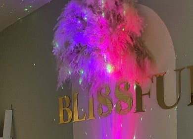 Vibrant lighting and feathers adorn Blissful Beauty and Massage Therapy in Glastonbury, England, GB.