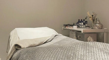 Relaxing treatment room at Blissful Beauty and Massage Therapy, Glastonbury, England, GB, with massage table.