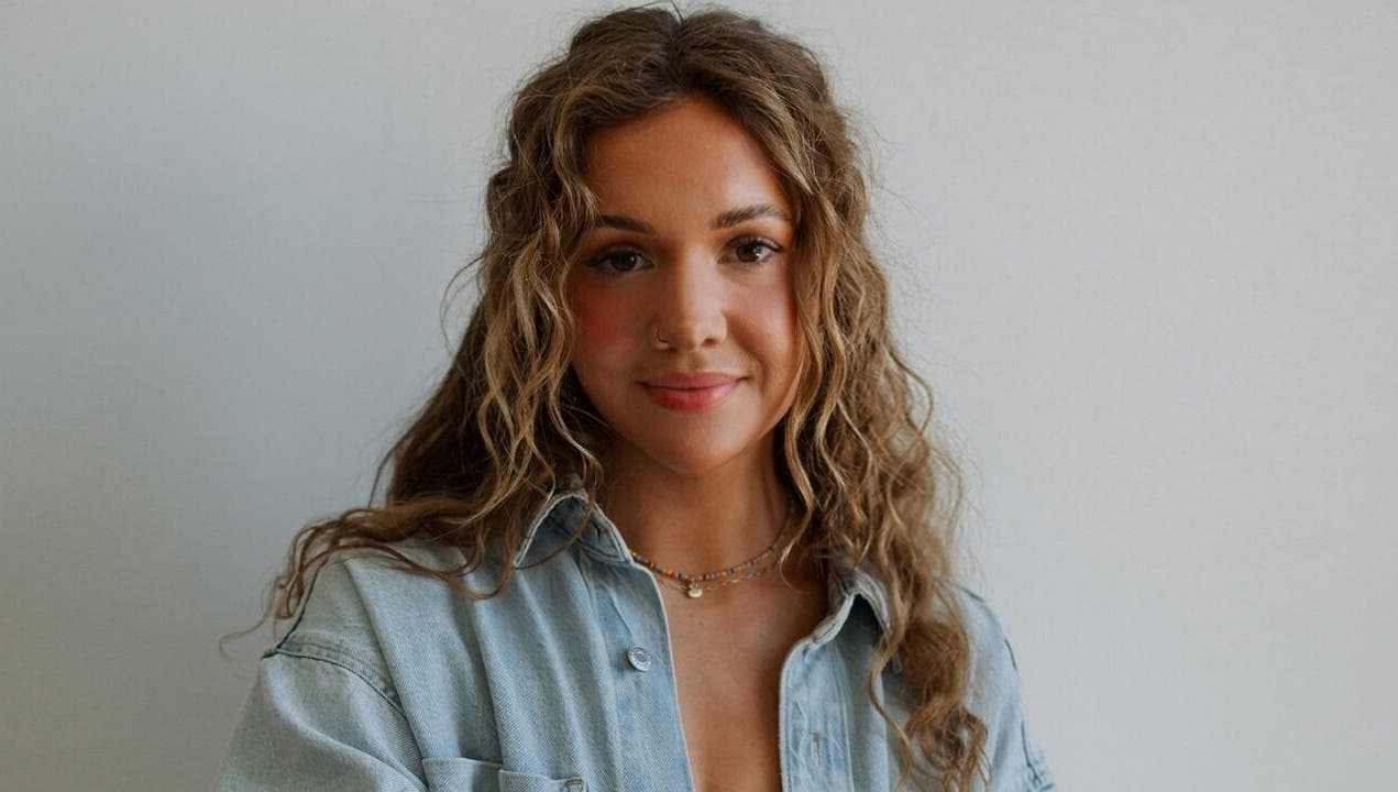 Warm portrait of a woman with curly hair at Studio Noir (Maddi), Appleton, Wisconsin, US.