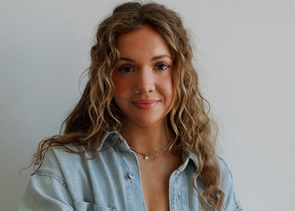 Warm portrait of a woman with curly hair at Studio Noir (Maddi), Appleton, Wisconsin, US.