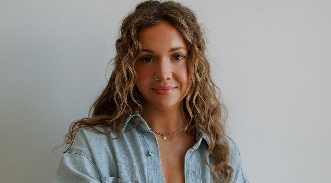 Warm portrait of a woman with curly hair at Studio Noir (Maddi), Appleton, Wisconsin, US.