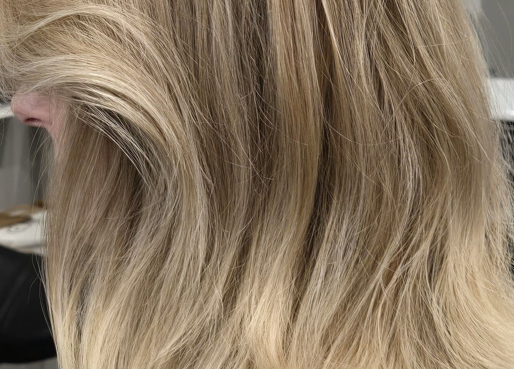 Gorgeous blonde hair styled at Studio Noir, Appleton, Wisconsin, US, showcasing silky waves and vibrant color.