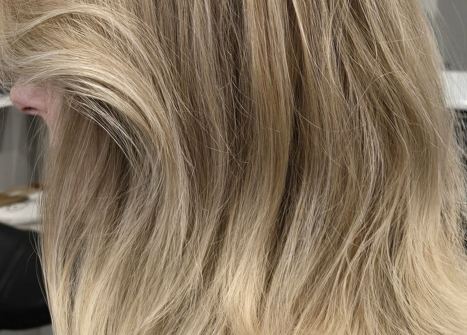 Gorgeous blonde hair styled at Studio Noir, Appleton, Wisconsin, US, showcasing silky waves and vibrant color.