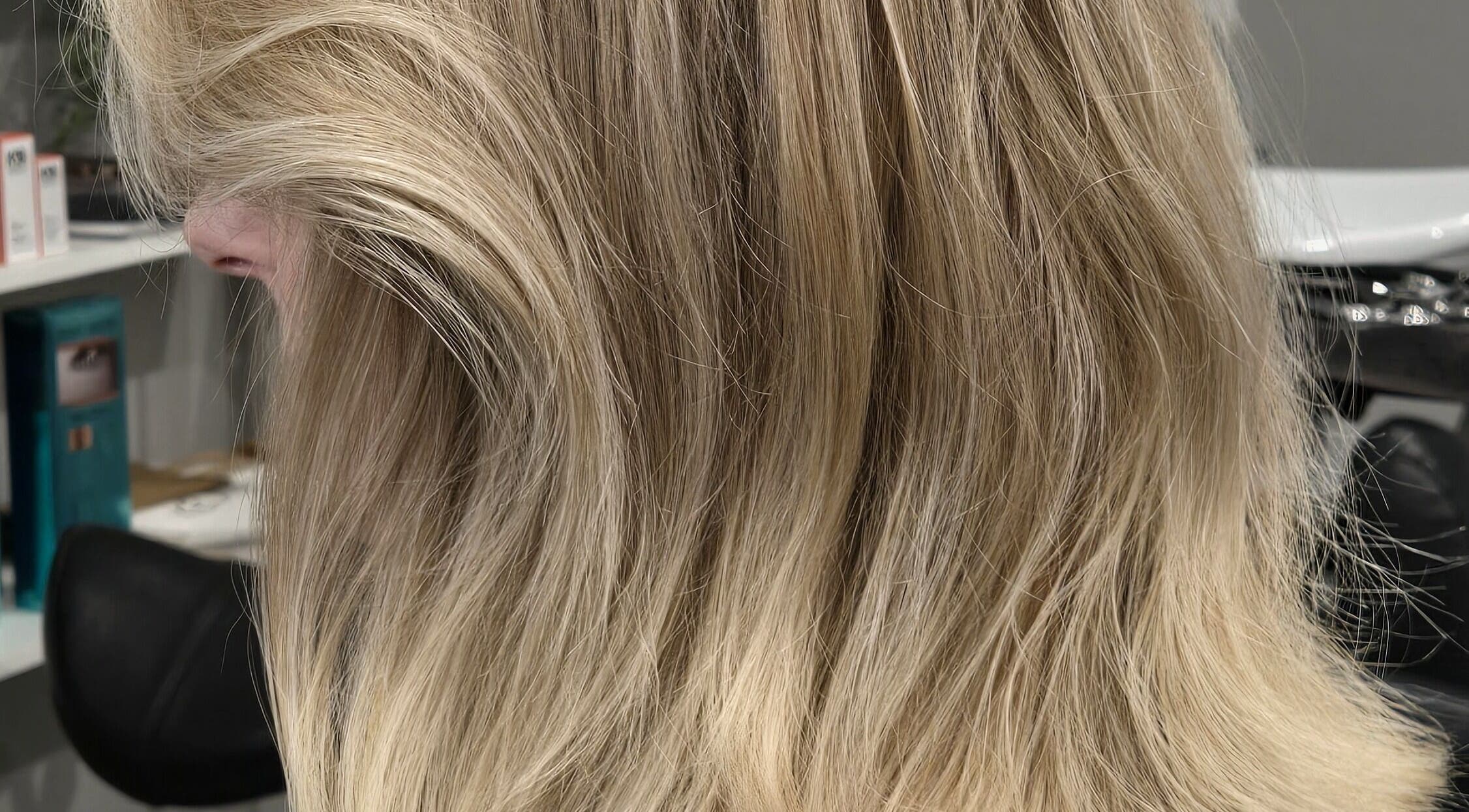 Gorgeous blonde hair styled at Studio Noir, Appleton, Wisconsin, US, showcasing silky waves and vibrant color.