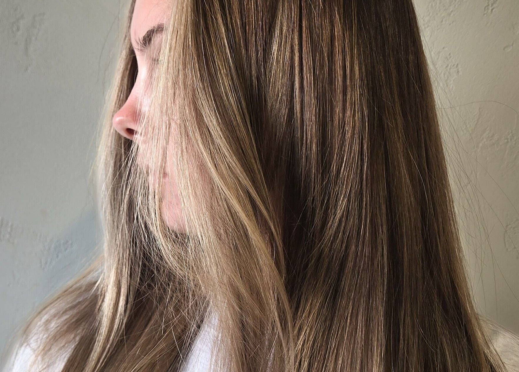 Beautifully styled hair at Studio Noir (Maddi), Appleton, Wisconsin, US, showcasing sleek and shiny blonde highlights.
