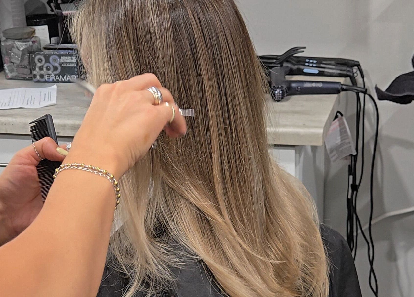 Stylist trimming hair at Studio Noir, Appleton, Wisconsin, US. Precision haircutting in a professional salon.