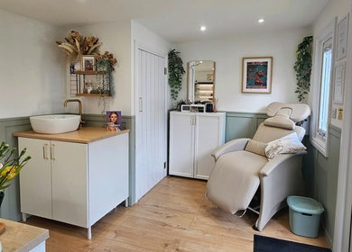 Serene beauty room at By the Shaw, Beer, England, GB featuring a plush reclining chair and elegant decor.