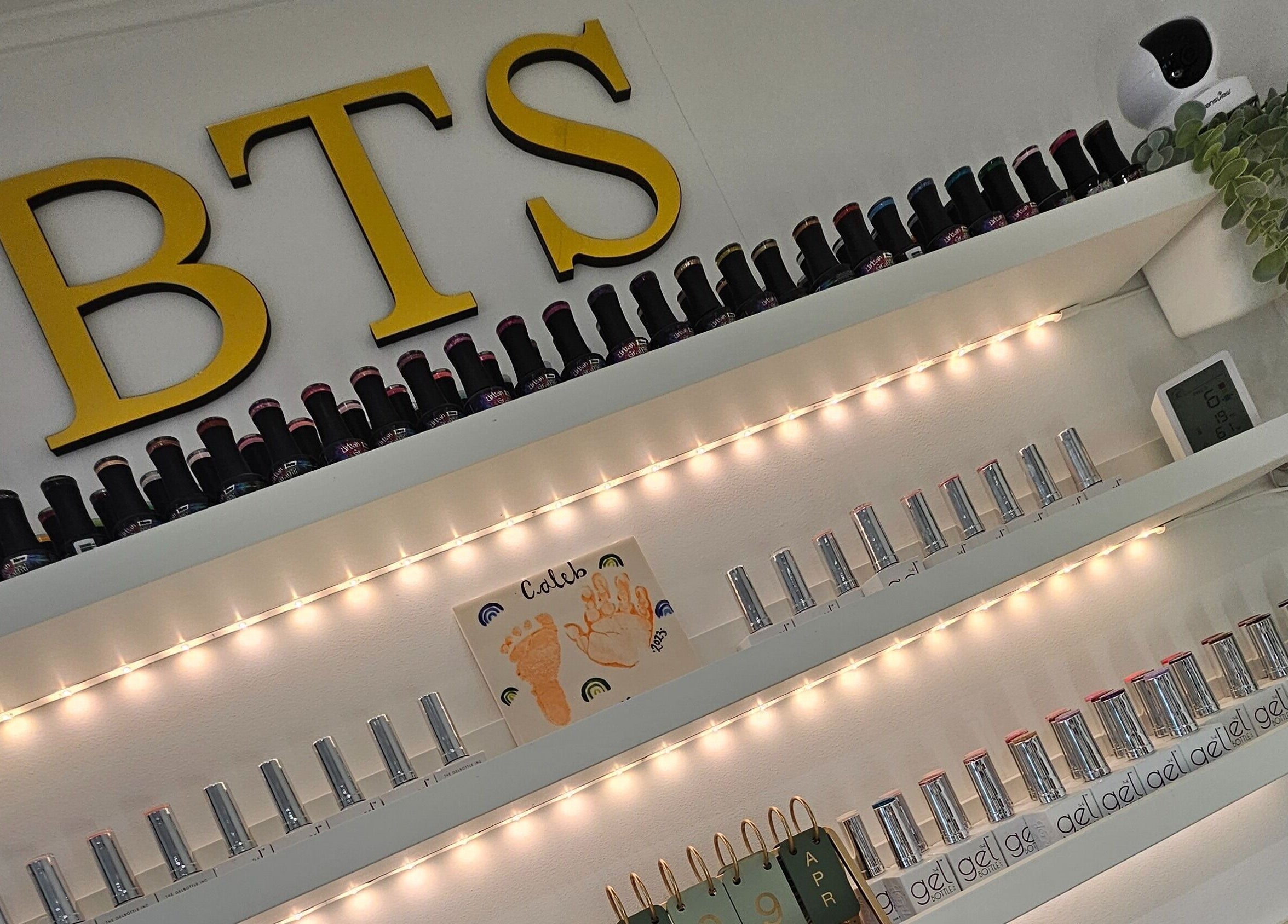 Elegant nail polish display at By the Shaw, Beer, England, GB with stylish shelving and ambient lighting.