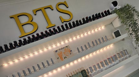 Elegant nail polish display at By the Shaw, Beer, England, GB with stylish shelving and ambient lighting.