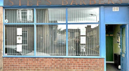Stefs barber's Forfar entrance in Forfar, Scotland, GB with blue door and large windows.