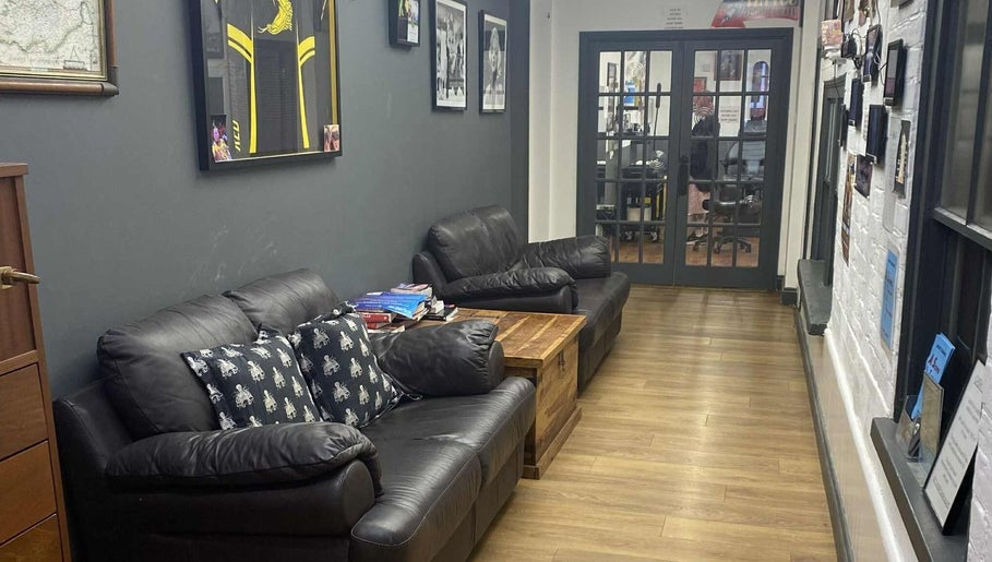 Comfortable leather seating area at Kracken Body Art, Gorleston-on-Sea, England, GB.