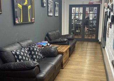 Comfortable leather seating area at Kracken Body Art, Gorleston-on-Sea, England, GB.